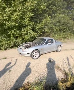 The MX-5 on gravel, bonnet open