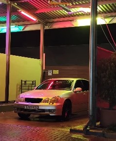 A car under coloured neon lights